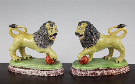 A pair of British pottery figures of lions, c.1820, 16cm., restorations